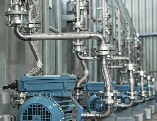 Detail of new blue electric motors with pumps on the stainless steel production line.