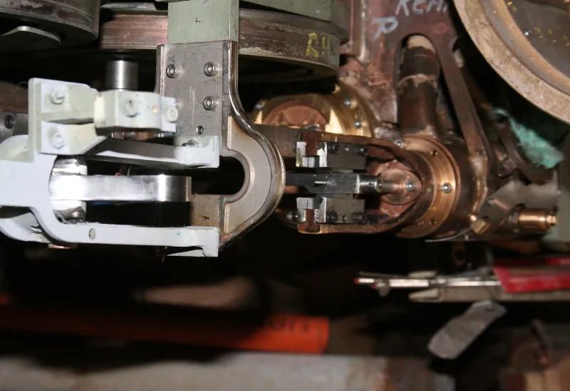 Close-up of a precision-engineered metal coupling and brake assembly on a model steam locomotive