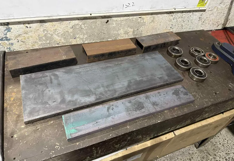 Steel plates and bearings prepared for machining and fabrication.